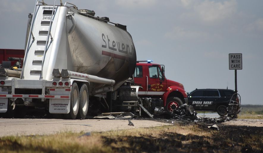 Grass along New Mexico State Route 128 near Jal shows burn marks following a fatal head-on crash Thursday, July 11, 2019. Authorities say four oilfield workers traveling in a pickup truck and the driver of a big rig were pronounced dead at the scene. (Jason Farmer/The Hobbs Daily News-Sun via AP)