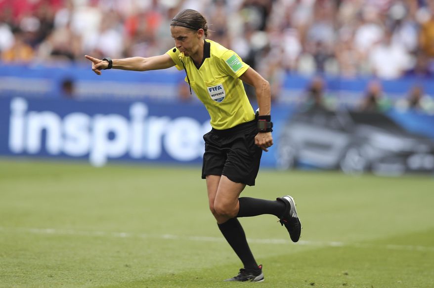 Referee Stephanie Frappart points to the penalty spot after checking the VAR during the Women's World Cup final soccer match between US and The Netherlands at the Stade de Lyon in Decines, outside Lyon, France, Sunday, July 7, 2019. (AP Photo/Francisco Seco)