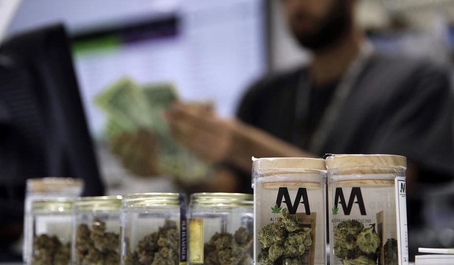 In this July 1, 2017, file photo, a cashier rings up a marijuana sale at a cannabis dispensary in Las Vegas, Nevada. (AP Photo/John Locher, File)