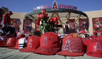 A makeshift shrine in honor of Los Angeles Angels pitcher Tyler Skaggs stands outside Angel Stadium before the team&#39;s baseball game against the Seattle Mariners on Friday, July 12, 2019, in Anaheim, Calif. (AP Photo/Marcio Jose Sanchez)
