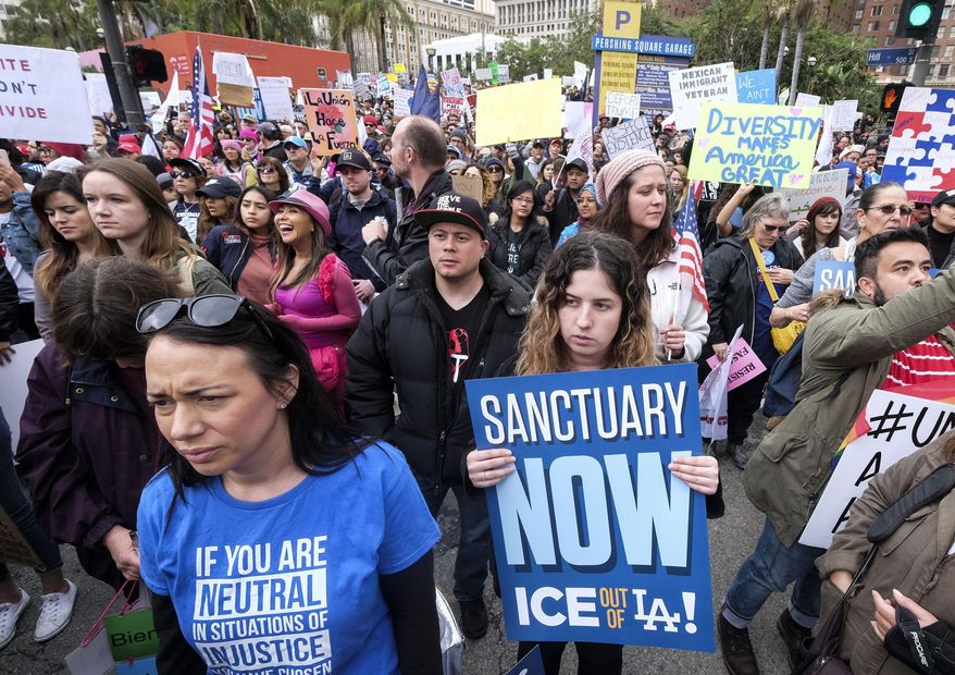 In this Feb. 18, 2017, file photo, thousands of people take part in the "Free the People Immigration March," to protest actions taken by President Donald Trump and his administration, in Los Angeles. A federal appeals court has given the Trump administration a rare legal win in its efforts to crack down on sanctuary cities. In a 2-1 decision Friday, July 12, 2019, the 9th U.S. Circuit Court of Appeals said the Justice Department was within its rights to give priority status for multimillion-dollar community policing grants to departments that agree to cooperate with immigration officials. (AP Photo/Ringo H.W. Chiu, File)