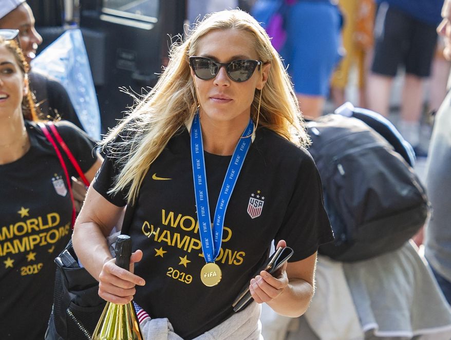 FILE - In this July 8, 2019 file photo, United States women's soccer team member Allie Long walks to a hotel Monday, July 8, 2019, in New York. The celebration was cut short for Long after she discovered someone had burglarized her hotel room in Los Angeles. She tweeted on Thursday, July 11, that it happened after the team was honored at The ESPYS on Wednesday night. (AP Photo/Corey Sipkin, File)