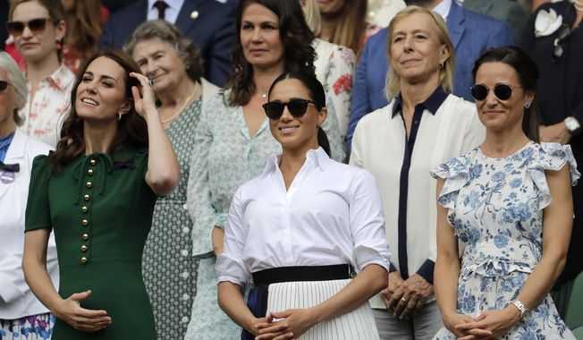 Kate, Duchess of Cambridge, Meghan, Duchess of Sussex and Pippa Matthews, foreground from left to right, stand together during the women&#x27;s singles final match on day twelve of the Wimbledon Tennis Championships in London, Saturday, July 13, 2019. (AP Photo/Ben Curtis)