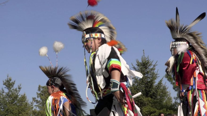 BC-WI--INN-Indian Community School In this June 7, 2019 photo, the late-afternoon sun highlights the dancers' colorful regalia at the Indian Community School during its its end-of-the-year powwow in Franklin, Wis. The powwow tradition is just a small but important part of the cultural programming at the Indian Community School, where the Our Ways initiative supports the school curriculum by connecting students with traditional practices and ways of life. (Photo by Mark Doremus/Milwaukee Neighborhood News Service via AP)