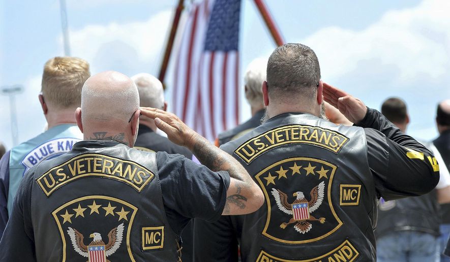 Members of the U.S. Veterans Motorcycle Club salute the flag during the playing of the National Anthem at the beginning of a memorial and remembrance service for seven motorcyclists and their spouses who died in the June crash  Saturday, July 13, 2019 in the parking lot of Gillette Stadium in Foxboro, Mass.  The seven bikers were killed when a pickup truck hauling a flatbed trailer slammed into a group of riders in Randolph, New Hampshire.  (Mark Stockwell/The Sun Chronicle via AP)