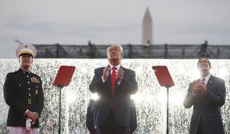 President Donald Trump, joined by Acting Secretary of Defense Mark Esper, right, and Joint Chiefs Chairman Gen. Joseph Dunford, left, stands on stage in the rain during an Independence Day celebration in front of the Lincoln Memorial, Thursday, July 4, 2019, in Washington. (AP Photo/Carolyn Kaster)
