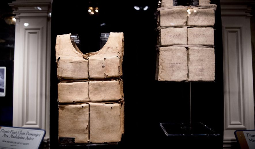 The life jackets of Madeline Astor and Laura Mabel Francatelli are displayed at the Titanic Museum in Pigeon Forge, Tenn. on Tuesday, July 9, 2019. The museum is showing six of the 12 known remaining life jackets from ship, including at least one worn by a survivor that&#39;s never been shown. (Calvin Mattheis/Knoxville News Sentinel via AP)