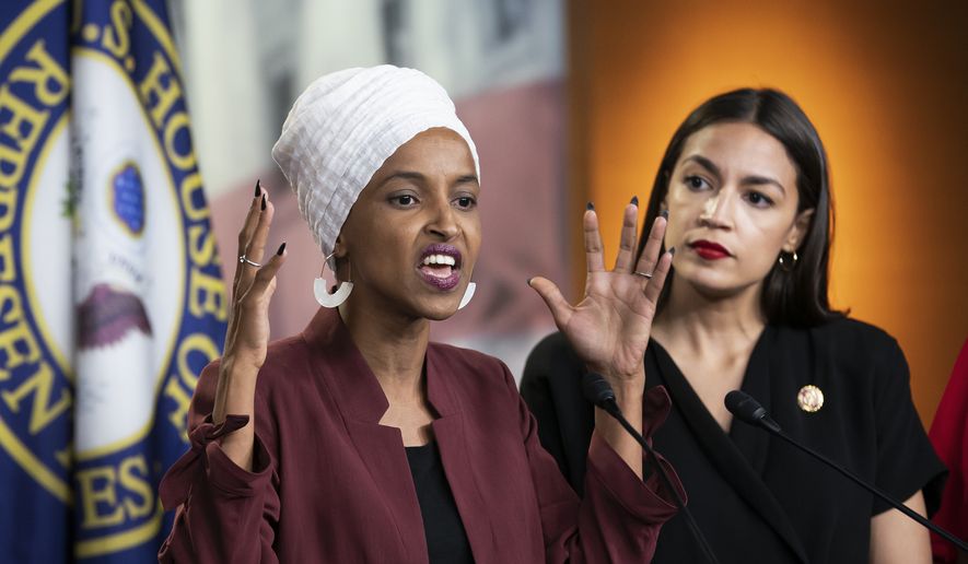 U.S. Rep. Ilhan Omar, D-Minn., left, joined at right by U.S. Rep. Alexandria Ocasio-Cortez, D-N.Y., responds to base remarks by President Donald Trump after he called for four Democratic congresswomen of color to go back to their &quot;broken&quot; countries, as he exploited the nation&#x27;s glaring racial divisions once again for political gain, during a news conference at the Capitol in Washington, Monday, July 15, 2019. All four congresswomen are American citizens and three of the four were born in the U.S. Omar is the first Somali-American in Congress. (AP Photo/J. Scott Applewhite)