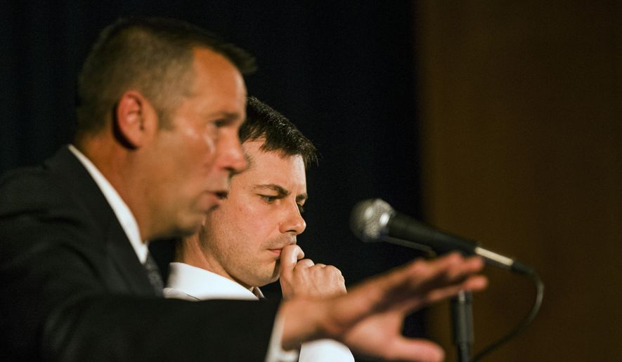In this June 23, 2019, file photo, South Bend Police Chief Scott Ruszkowski, left, speaks as Democratic presidential candidate and South Bend Mayor Pete Buttigieg listens during a town hall community meeting, in South Bend, Ind. A white Indiana police officer who fatally shot a black man, sparking protests and roiling the presidential campaign of Mayor Pete Buttigieg, has resigned. The Fraternal Order of Police announced Sgt. Ryan O’Neill’s resignation from the South Bend Police Department on Monday, July 15. (Robert Franklin/South Bend Tribune via AP, File)