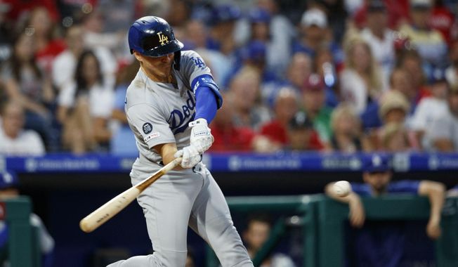 Los Angeles Dodgers&#x27; Enrique Hernandez hits an RBI-single off Philadelphia Phillies starting pitcher Zach Eflin during the fourth inning of a baseball game, Monday, July 15, 2019, in Philadelphia. (AP Photo/Matt Slocum)