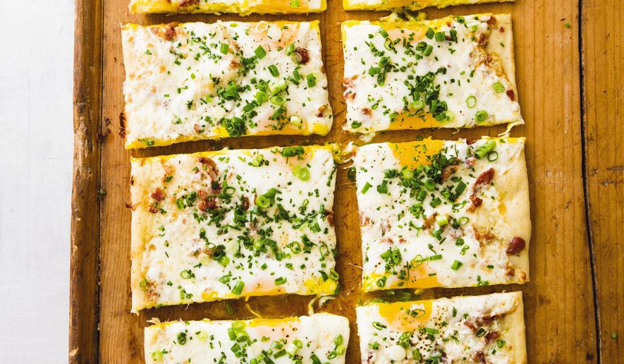 This undated photo provided by America's Test Kitchen in July 2019 shows Breakfast Pizza in Brookline, Mass. This recipe appears in the cookbook "New Essentials." (Joe Keller/America's Test Kitchen via AP)