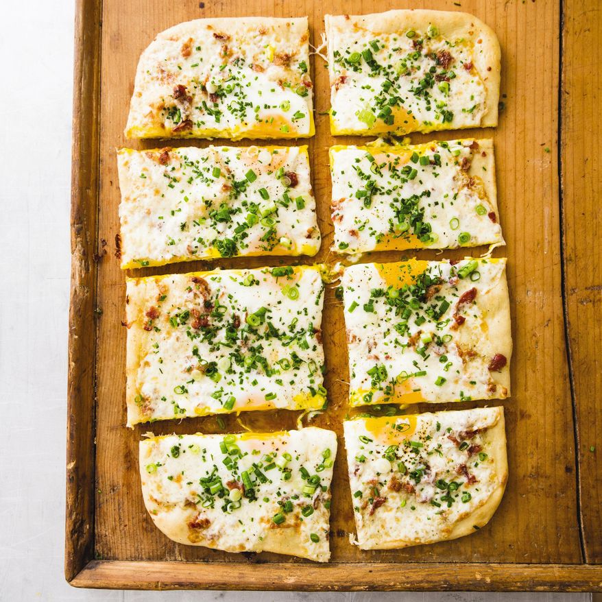 This undated photo provided by America's Test Kitchen in July 2019 shows Breakfast Pizza in Brookline, Mass. This recipe appears in the cookbook "New Essentials." (Joe Keller/America's Test Kitchen via AP)