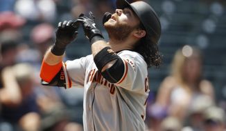 San Francisco Giants&#39; Brandon Crawford gestures as he crosses home plate after hitting a two-run home run off Colorado Rockies relief pitcher Jesus Tinoco in the sixth inning of a baseball game Monday, July 15, 2019, in Denver.(AP Photo/David Zalubowski)