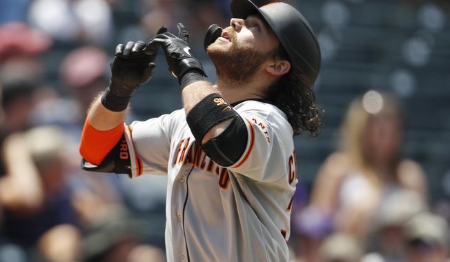 San Francisco Giants&#x27; Brandon Crawford gestures as he crosses home plate after hitting a two-run home run off Colorado Rockies relief pitcher Jesus Tinoco in the sixth inning of a baseball game Monday, July 15, 2019, in Denver.(AP Photo/David Zalubowski)