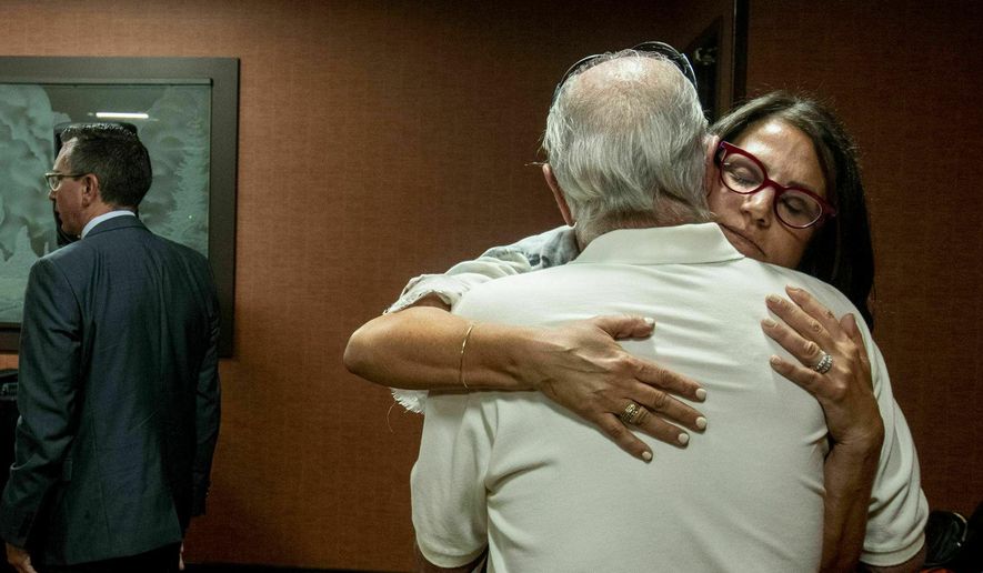 Tanya Gersh, a Montana real estate agent, embraces her father Lloyd Rosenstein following a hearing at the Russell Smith Federal Courthouse on Thursday, July 11, 2019, in Missoula. Gersh is the plaintiff in a harassment lawsuit filed against Daily Stormer publisher Andrew Anglin. Gersh, who is Jewish, said she and her family received hundreds of threatening messages, many of them anti-Semitic. (Ben Allen/The Missoulian via AP)