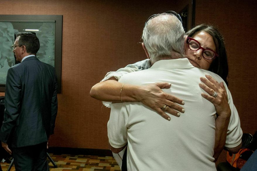 Tanya Gersh, a Montana real estate agent, embraces her father Lloyd Rosenstein following a hearing at the Russell Smith Federal Courthouse on Thursday, July 11, 2019, in Missoula. Gersh is the plaintiff in a harassment lawsuit filed against Daily Stormer publisher Andrew Anglin. Gersh, who is Jewish, said she and her family received hundreds of threatening messages, many of them anti-Semitic. (Ben Allen/The Missoulian via AP)