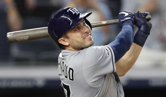Tampa Bay Rays&#x27; Travis d&#x27;Arnaud watches his three-run home run during the ninth inning of a baseball game against the New York Yankees, Monday, July 15, 2019, in New York. It was d&#x27;Arnaud&#x27;s third home run of the game. (AP Photo/Kathy Willens)