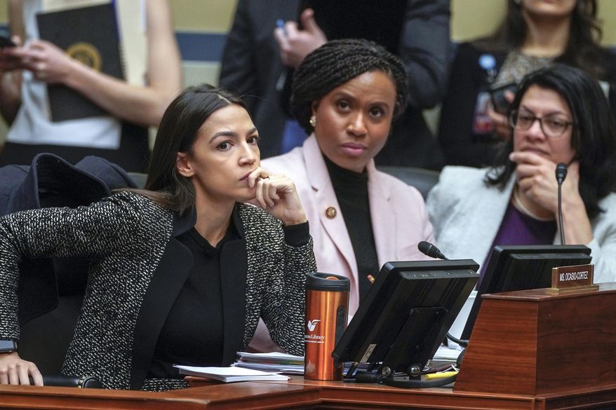 In this Feb. 26, 2019, file photo, Rep. Alexandria Ocasio-Cortez, D-N.Y., left, joined by Rep. Ayanna Pressley, D-Mass., and Rep. Rashida Tlaib, D-Mich., listens during a House Oversight and Reform Committee meeting on Capitol Hill in Washington. In tweets Sunday, July 14, 2019, President Donald Trump portrays the lawmakers as foreign-born troublemakers who should go back to their home countries. In fact, the lawmakers, except one, were born in the U.S. He didn’t identify the women but was referring to Reps. Ocasio-Cortez, Pressley, Tlaib and Ilhan Omar. (AP Photo/J. Scott Applewhite, File)