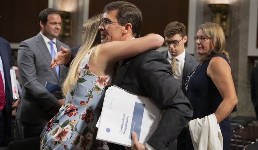 Secretary of the Army and Secretary of Defense nominee Mark Esper gets a hug from his daughter Kate Esper, as his Senate Armed Services Committee confirmation hearing concludes on Capitol Hill in Washington, Tuesday, July 16, 2019. Esper&#39;s wife Leah Esper, back right, and son John Esper, watch. (AP Photo/Manuel Balce Ceneta)