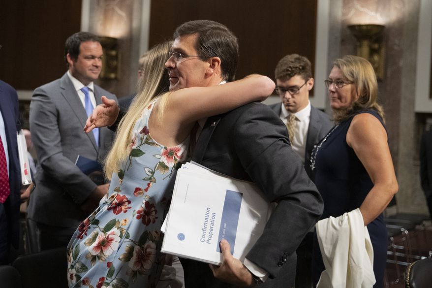 Secretary of the Army and Secretary of Defense nominee Mark Esper gets a hug from his daughter Kate Esper, as his Senate Armed Services Committee confirmation hearing concludes on Capitol Hill in Washington, Tuesday, July 16, 2019. Esper&#39;s wife Leah Esper, back right, and son John Esper, watch. (AP Photo/Manuel Balce Ceneta)