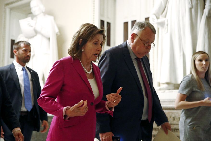 House Speaker Nancy Pelosi of Calif., left, walks out of the House Chamber, Tuesday, July 16, 2019, on Capitol Hill in Washington. (AP Photo/Patrick Semansky)