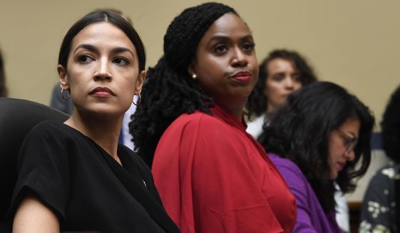 Rep. Alexandria Ocasio-Cortez, D-N.Y., left, Rep. Ayanna Pressley, D-Mass., center, and Rep. Rashida Tlaib, D-Mich., right, attend a House Oversight Committee hearing on Capitol Hill in Washington, Monday, July 15, 2019, on White House counselor Kellyanne Conway&#x27;s violation of the Hatch Act. (AP Photo/Susan Walsh)