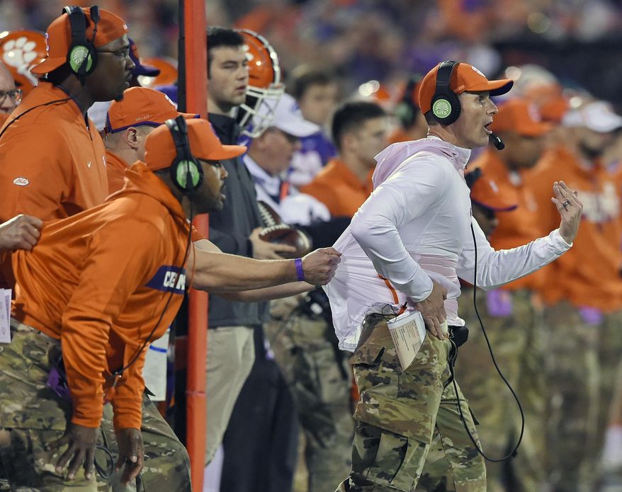 FILE - In this Nov. 17, 2018, file photo, Clemson defensive coach Brent Venables is pulled back by an assistant during the first half of an NCAA college football game in Clemson, S.C. Clemson’s defense was a big reason why the Tigers won a second national championship in three seasons. Now that unit has massive holes to fill after losing its entire front to the NFL, along with three key linebackers and two members of the secondary _ and that could mean the Tigers have to win shootouts behind quarterback Trevor Lawrence to stay on top. (AP Photo/Richard Shiro, File)
