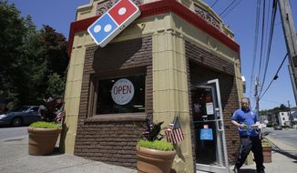 In this Monday, July 15, 2019 photo a customer departs a Domino&#39;s location holding food items, in Norwood, Mass. Domino&#39;s Pizza Inc. reports earns Tuesday, July 16. (AP Photo/Steven Senne)