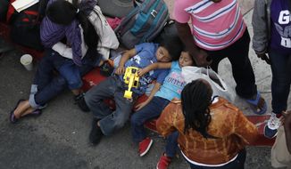 People wait to apply for asylum in the United States along the border, Tuesday, July 16, 2019, in Tijuana, Mexico. Dozens of immigrants lined up Tuesday at a major Mexico border crossing, waiting to learn how the Trump administration&#39;s plans to end most asylum protections would affect their hopes of taking refuge in the United States. (AP Photo/Gregory Bull)