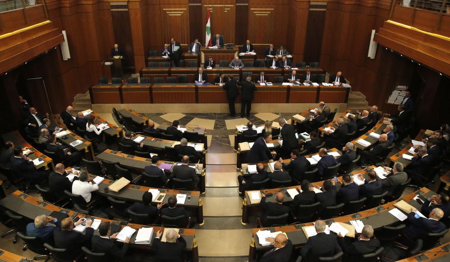 Lebanese lawmakers and ministers meet at the parliament building during the opening session of the draft 2019 state budget, in Beirut, Lebanon, Tuesday, July 16, 2019. Lebanese lawmakers have begun discussing the budget amid tight security and limited protests against proposed austerity measures. The proposed budget aims to avert a financial crisis by raising taxes and cutting public spending in an effort to reduce a ballooning deficit. (AP Photo/Hussein Malla)