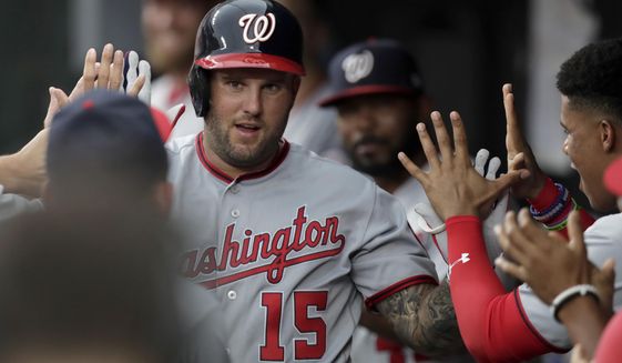 Washington Nationals&#39; Matt Adams is greeted in the dugout after hitting a solo home run off Baltimore Orioles starting pitcher Asher Wojciechowski during the second inning of a baseball game, Tuesday, July 16, 2019, in Baltimore. (AP Photo/Julio Cortez)