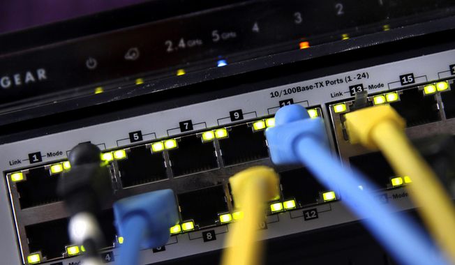 In this June 19, 2018, photo, a router and internet switch are displayed in East Derry, N.H. The FBI said cyberattacks have become common at schools, which are attractive targets because they hold sensitive data and provide critical public services. Malicious use of the data could lead to bullying, tracking and identity theft, the agency said. (AP Photo/Charles Krupa) **FILE**
