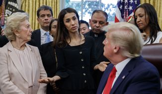 President Donald Trump listens to Nobel Peace Prize winner Nadia Murad, a Yazidi from Iraq, center, as he meets with survivors of religious persecution in the Oval Office of the White House on Wednesday, July 17, 2019, in Washington. The survivors come from countries including, Myanmar, New Zealand, Yemen, China, Cuba, Eritrea, Nigeria, Turkey, Vietnam, Sudan, Iraq, Afghanistan, North Korea, Sri Lanka, Pakistan, Iran and Germany. (AP Photo/Alex Brandon)