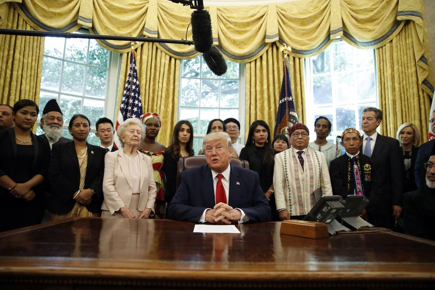 President Donald Trump speaks as he meets with survivors of religious persecution in the Oval Office of the White House on Wednesday, July 17, 2019, in Washington. The survivors come from countries including, Myanmar, New Zealand, Yemen, China, Cuba, Eritrea, Nigeria, Turkey, Vietnam, Sudan, Iraq, Afghanistan, North Korea, Sri Lanka, Pakistan, Iran and Germany.(AP Photo/Alex Brandon)