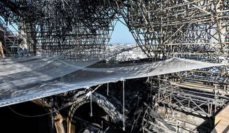 Parts of a destroyed ribbed vault and scaffolding are pictured at the Notre-Dame de Paris Cathedral, Wednesday, July 17, 2019 in Paris. The chief architect of France&#39;s historic monuments says that three months after the April 15 fire that devastated Notre Dame Cathedral the site is still being secured. (Stephane de Sakutin/Pool via AP)