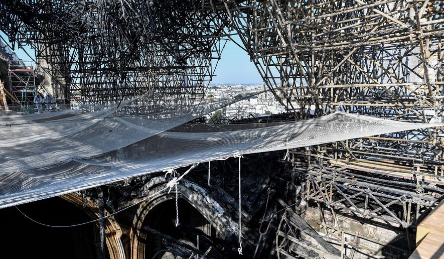Parts of a destroyed ribbed vault and scaffolding are pictured at the Notre-Dame de Paris Cathedral, Wednesday, July 17, 2019 in Paris. The chief architect of France&#x27;s historic monuments says that three months after the April 15 fire that devastated Notre Dame Cathedral the site is still being secured. (Stephane de Sakutin/Pool via AP)