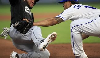 Kansas City Royals third baseman Cheslor Cuthbert, right, tags out Chicago White Sox&#39;s Welington Castillo (21) during the fifth inning of a baseball game at Kauffman Stadium in Kansas City, Mo., Wednesday, July 17, 2019.  (AP Photo/Orlin Wagner)