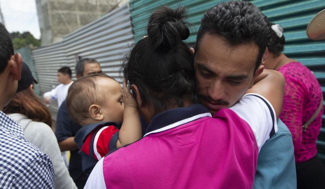 A Guatemalan migrant, who was deported from the United States, embraces relatives after arriving at the Air Force Base in Guatemala City, Tuesday, July 16, 2019. Nearly 200 Guatemalan migrants have been deported on Tuesday, the day the Trump administration planned to launch a drastic policy change designed to end asylum protections for most migrants who travel through another country to reach the United States. (AP Photo/Moises Castillo)