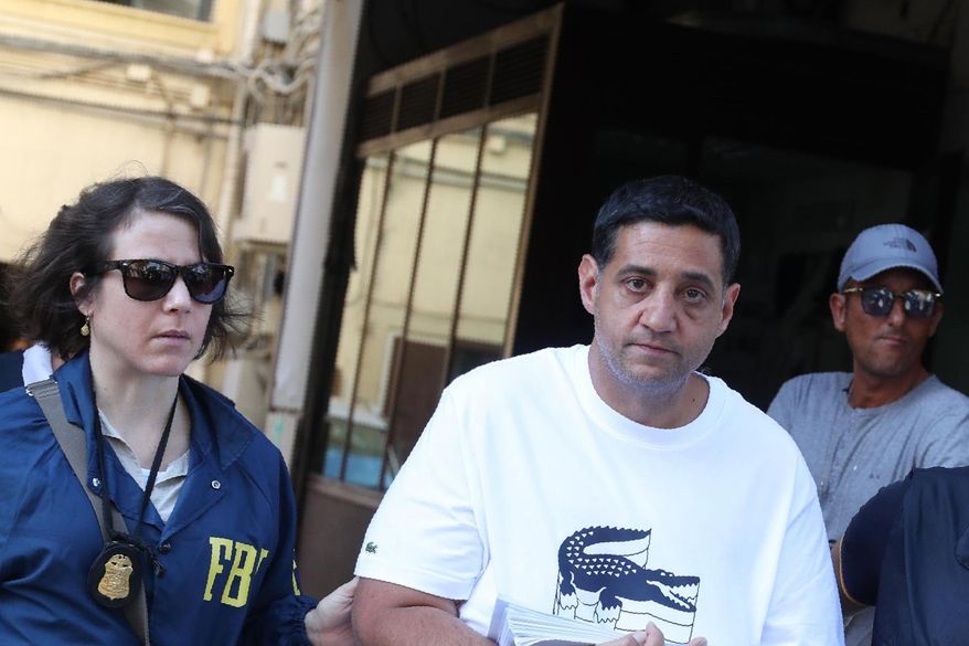 Suspect Thomas Gambino, right, is taken into custody during an anti-mafia operation lead by the Italian Police and the FBI in Palermo, Southern Italy, Wednesday, July 17, 2019. Italian police and the FBI arrested 19 suspected Mafiosi in a joint operation Wednesday following an investigation which revealed alleged ties between Sicily's Cosa Nostra Mafia and New York's Gambino crime family. (Igor Petix/ANSA Via AP)