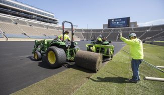 Natural turf is installed at Notre Dame Stadium in preparation for a professional soccer match in South Bend, Ind., Monday, July 15, 2019. Crews began unrolling large rolls of turf at the stadium Monday ahead of Friday&#39;s scheduled friendly matchup between Liverpool F.C. and Borussia Dortmund. (Santiago Flores/South Bend Tribune via AP)