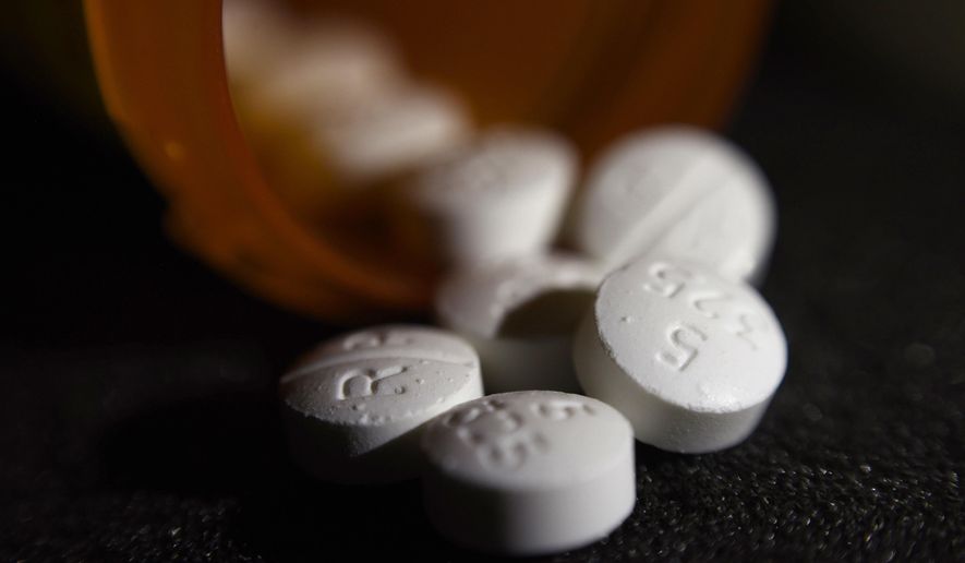 FILE - This Tuesday, Aug. 15, 2017, file photo shows an arrangement of pills of the opioid oxycodone-acetaminophen in New York. Newly released federal data shows how drugmakers and distributors increased shipments of opioid painkillers across the U.S. as the nation’s addiction crisis accelerated from 2006 to 2012. (AP Photo/Patrick Sison, File)