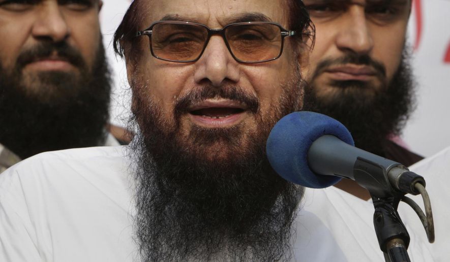 FILE - In this Friday, Oct. 26, 2018 file photo, Hafiz Saeed, founder of Pakistani religious group Jamaat-ud-Dawa addresses an anti-Indian rally in Lahore, Pakistan. Pakistani authorities say they have arrested Saeed, a radical cleric and U.S.-wanted terror suspect blamed for the 2008 Mumbai attacks, just days ahead of Prime Minister Imran Khan&#x27;s trip to Washington. (AP Photo/K.M. Chaudary, File)