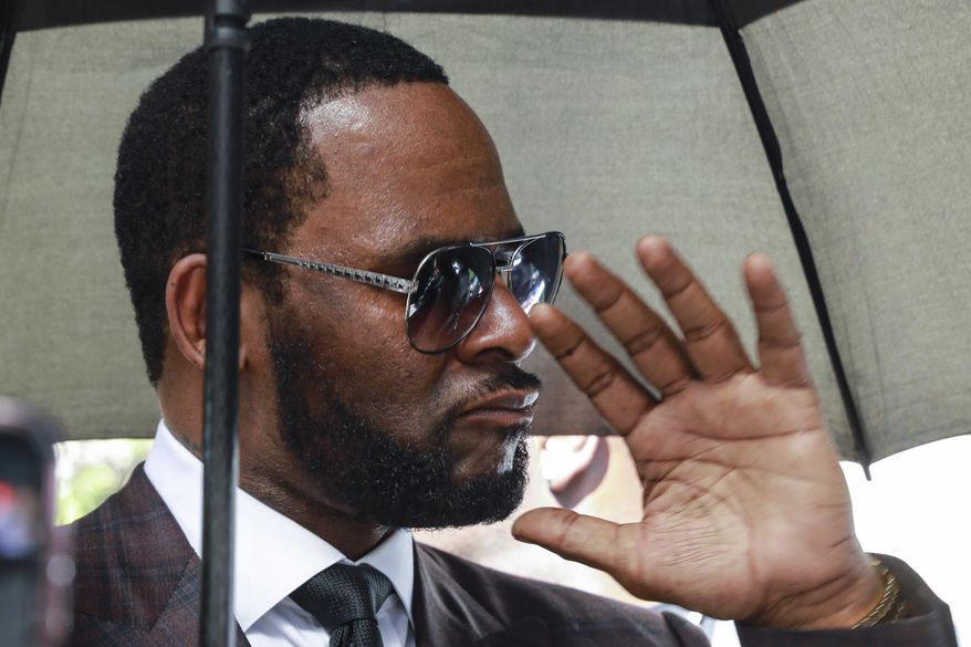 FILE - In this June 26, 2019, file photo, Musician R. Kelly departs from the Leighton Criminal Court building after a status hearing in his criminal sexual abuse trial in Chicago. Fighting federal child sex crime charges is already proving to be a different experience for Kelly than when he successfully fought child pornography charges in state court. A judge ordered him held in federal custody without bond Tuesday, instead of releasing him on bond as before his 2008 trial. (AP Photo/Amr Alfiky, File)