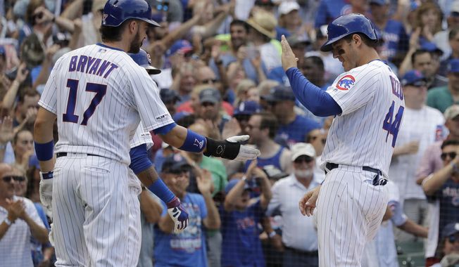 Chicago Cubs&#x27; Anthony Rizzo, right, celebrates with Kris Bryant after they scored on a two-run double by Jason Heyward during the seventh inning of a baseball game against the Cincinnati Reds in Chicago, Wednesday, July 17, 2019. (AP Photo/Nam Y. Huh)