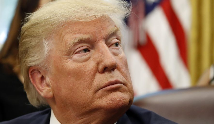 President Donald Trump listens as he meets with survivors of religious persecution in the Oval Office of the White House on Wednesday, July 17, 2019, in Washington. The survivors come from countries including, Myanmar, New Zealand, Yemen, China, Cuba, Eritrea, Nigeria, Turkey, Vietnam, Sudan, Iraq, Afghanistan, North Korea, Sri Lanka, Pakistan, Iran and Germany.(AP Photo/Alex Brandon)