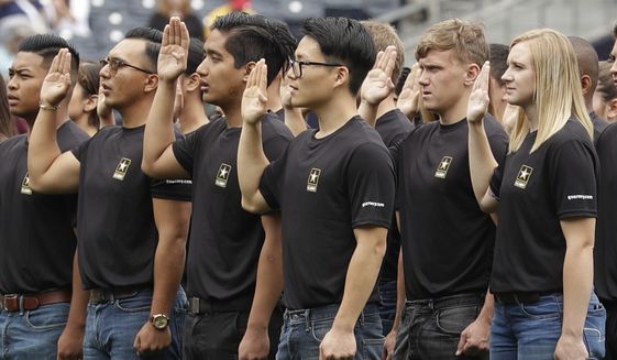 In this June 4, 2017, file photo. nNew Army recruits take part in a swearing in ceremony before a baseball game between the San Diego Padres and the Colorado Rockies in San Diego. The Army has missed its recruiting goal for the first time in more than a decade. Army leaders tell The Associated Press they signed up about 70,000 new troops for the fiscal year that ends Sept. 30, 2018. (AP Photo/Gregory Bull, File)