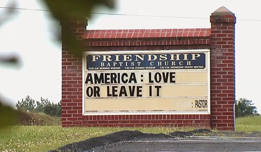 This image taken from video provided by WSET-TV shows a sign "America: Love it or Leave It." posted outside the Friendship Baptist Church in Appomattox, Va., on Tuesday, July 16, 2019. Amid a national furor over President Donald Trumps tweet urging four Democratic congresswomen to go back to their home countries, Pastor E. W. Lucas is gaining attention with the sign at his church (WSET-TV via AP) . MANDATORY CREDIT LYNCHBURG AND ROANOKE OUT