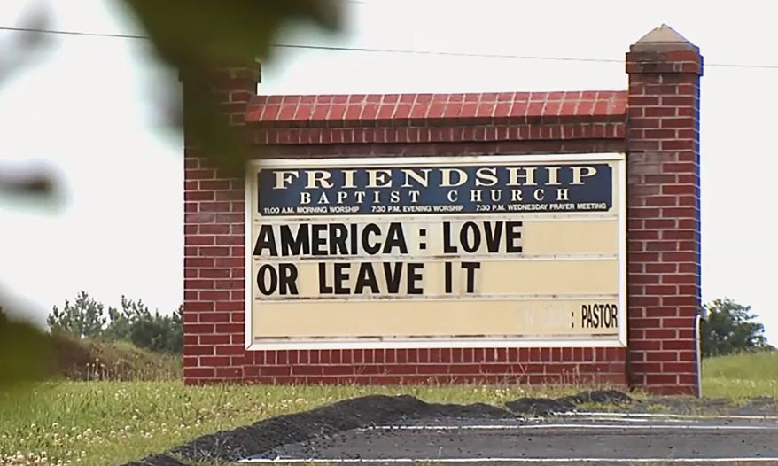 This image taken from video provided by WSET-TV shows a sign "America: Love it or Leave It." posted outside the Friendship Baptist Church in Appomattox, Va., on Tuesday, July 16, 2019. Amid a national furor over President Donald Trumps tweet urging four Democratic congresswomen to go back to their home countries, Pastor E. W. Lucas is gaining attention with the sign at his church (WSET-TV via AP) . MANDATORY CREDIT LYNCHBURG AND ROANOKE OUT