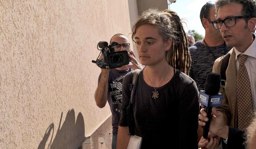 Sea-Watch3 German captain Carola Rackete is accompanied by her lawyer Leonardo Marino, right, as she arrives for questioning in court in the southern Sicilian town of Agrigento, Italy, Thursday, July 18, 2019. Rackete, who forced a government block docking at an Italian port after rescuing migrants, faces questioning by Italian prosecutors over allegedly aiding illegal immigration. (Pasquale Claudio Montana Lampo/ANSA via AP)