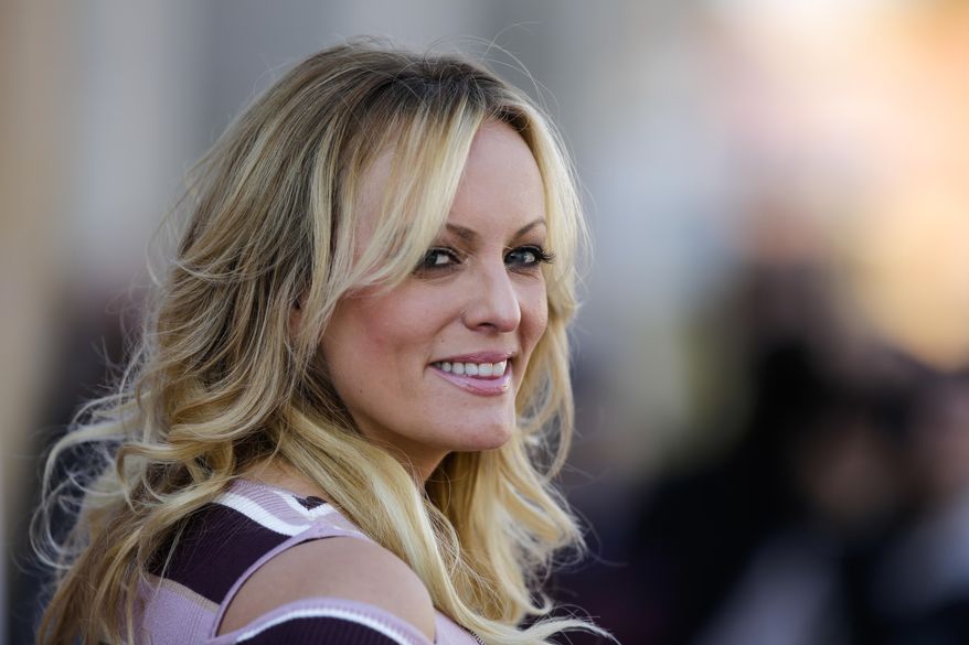 In this Oct. 11, 2018, file photo, adult film actress Stormy Daniels attends the opening of the adult entertainment fair &#39;Venus&#39; in Berlin, Germany. Search warrants unsealed Thursday, Jul 18, 2019, shed new light on President Donald Trump&#39;s role as his campaign scrambled to respond to media inquiries about hush money paid to two women who said they had affairs with him. The investigation involved payments Trump&#39;s attorney Michael Cohen helped orchestrate to Daniels and Playboy centerfold Karen McDougal. (AP Photo/Markus Schreiber, File)